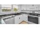 Updated kitchen with stainless steel appliances and granite countertops at 3021 Countryside Blvd # 28A, Clearwater, FL 33761