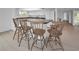 Kitchen island with granite countertop and four wooden barstools at 3021 Countryside Blvd # 28A, Clearwater, FL 33761