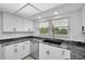 Modern kitchen with granite counters, white cabinets, and stainless steel appliances at 3021 Countryside Blvd # 28A, Clearwater, FL 33761