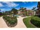 Landscaped walkway leading to community pool and building at 3021 Countryside Blvd # 28A, Clearwater, FL 33761