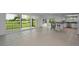Bright living room with tile floors, sliders to balcony, and view of golf course at 3021 Countryside Blvd # 28A, Clearwater, FL 33761