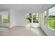 Spacious living area with tile floors and multiple windows at 3021 Countryside Blvd # 28A, Clearwater, FL 33761