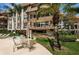 Patio furniture with umbrella near condo building and landscaping at 3021 Countryside Blvd # 28A, Clearwater, FL 33761