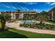 Inviting community pool with lounge chairs and landscaping at 3021 Countryside Blvd # 28A, Clearwater, FL 33761