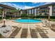 Relaxing community pool area with lounge chairs at 3021 Countryside Blvd # 28A, Clearwater, FL 33761