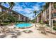 Inviting community pool with lounge chairs and patio tables at 3021 Countryside Blvd # 28A, Clearwater, FL 33761