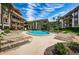 Community pool with plenty of lounge chairs at 3021 Countryside Blvd # 28A, Clearwater, FL 33761