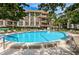 Refreshing community pool with surrounding patio furniture at 3021 Countryside Blvd # 28A, Clearwater, FL 33761