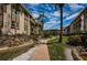 Paved walkway winds through a lush tropical garden setting near condo building at 3021 Countryside Blvd # 28A, Clearwater, FL 33761