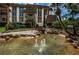 Charming pond with fountain, landscaping, and a wooden footbridge at 3021 Countryside Blvd # 28A, Clearwater, FL 33761