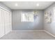 Grey bedroom with built-in closet and window at 3047 Enisglen Dr, Palm Harbor, FL 34683