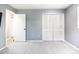 Simple bedroom with grey walls and a large closet at 3047 Enisglen Dr, Palm Harbor, FL 34683