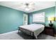 Bedroom with light teal walls, ceiling fan, and a bed at 3047 Enisglen Dr, Palm Harbor, FL 34683