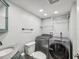 Laundry room with washer, dryer, and shelving at 3047 Enisglen Dr, Palm Harbor, FL 34683
