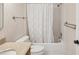 Bathroom with a granite countertop, toilet, and a tiled bathtub shower combo at 3332 Mcmath Dr, Palm Harbor, FL 34684
