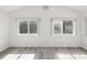 Bedroom with vaulted ceiling, fan and two bright windows overlooking greenery at 3332 Mcmath Dr, Palm Harbor, FL 34684