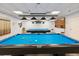 Recreation room with a well-maintained billiard table, cues, and comfortable seating, great for leisure at 3332 Mcmath Dr, Palm Harbor, FL 34684