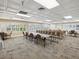 Well-lit conference room with large windows, tables, and chairs, ideal for meetings and discussions at 3332 Mcmath Dr, Palm Harbor, FL 34684