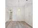 Bright dining room with modern flooring and a decorative hanging light fixture at 3332 Mcmath Dr, Palm Harbor, FL 34684
