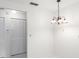 Hallway with a large double door closet and a hanging light fixture at 3332 Mcmath Dr, Palm Harbor, FL 34684