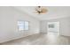 Bright living room with modern flooring, fan and a large window at 3332 Mcmath Dr, Palm Harbor, FL 34684