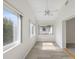 Sunlit living room with modern windows, light walls, ceiling fan and wood floors at 3332 Mcmath Dr, Palm Harbor, FL 34684