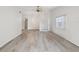 Spacious living room boasts wood flooring, a ceiling fan, and plenty of light at 3332 Mcmath Dr, Palm Harbor, FL 34684