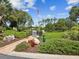 Picturesque community memorial garden with manicured lawns, garden beds, and a flagpole displaying the American flag at 3332 Mcmath Dr, Palm Harbor, FL 34684