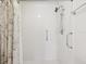 Shower stall featuring white tile, safety bar and a shower curtain rod at 3332 Mcmath Dr, Palm Harbor, FL 34684