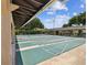Outdoor shuffleboard area with multiple lanes and a covered seating area, perfect for community recreation at 3332 Mcmath Dr, Palm Harbor, FL 34684