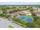 Aerial view showing community amenities including tennis courts and pool at 2711 Coldstone Ln, Holiday, FL 34691