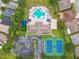 Aerial view of community pool, tennis courts, and homes at 2711 Coldstone Ln, Holiday, FL 34691