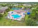 Community pool, tennis courts, and clubhouse aerial view at 2711 Coldstone Ln, Holiday, FL 34691