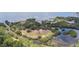 Aerial view of waterfront land with lush vegetation and a canal at 2711 Coldstone Ln, Holiday, FL 34691