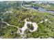 Aerial view of a park with a parking lot and trails at 2711 Coldstone Ln, Holiday, FL 34691