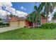 Attractive single-story home with a three-car garage and manicured lawn at 2711 Coldstone Ln, Holiday, FL 34691