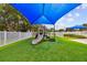 Playground with a slide and shade canopy at 2711 Coldstone Ln, Holiday, FL 34691