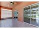 Enclosed patio with tile floors, sliding glass doors, and a ceiling fan at 2711 Coldstone Ln, Holiday, FL 34691