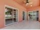 Bright screened patio featuring tile floors and multiple sliding glass doors at 2711 Coldstone Ln, Holiday, FL 34691