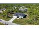 New construction home on a large lot with surrounding trees at 9333 Hialeah Ter, Port Charlotte, FL 33981