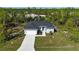 New single-Gathering home with driveway and landscaping; located in a wooded area at 9333 Hialeah Ter, Port Charlotte, FL 33981