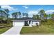 Single-story house with a grey exterior and a spacious yard at 9333 Hialeah Ter, Port Charlotte, FL 33981