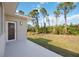 Side patio with view of backyard and trees at 9333 Hialeah Ter, Port Charlotte, FL 33981