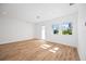 Bright and airy bedroom with hardwood floors and access to a balcony at 9333 Hialeah Ter, Port Charlotte, FL 33981