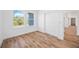 Bedroom with double door closet and wood-look floors at 9333 Hialeah Ter, Port Charlotte, FL 33981