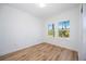 Bright bedroom with wood-look floors and window at 9333 Hialeah Ter, Port Charlotte, FL 33981