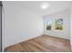 Bedroom featuring wood-look floors and two windows at 9333 Hialeah Ter, Port Charlotte, FL 33981