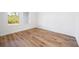 Bright bedroom with wood-look floors and large window at 9333 Hialeah Ter, Port Charlotte, FL 33981