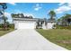 Single story home with grey exterior, white garage door and green grass at 9333 Hialeah Ter, Port Charlotte, FL 33981