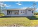Rear view of single story house with large yard at 9333 Hialeah Ter, Port Charlotte, FL 33981